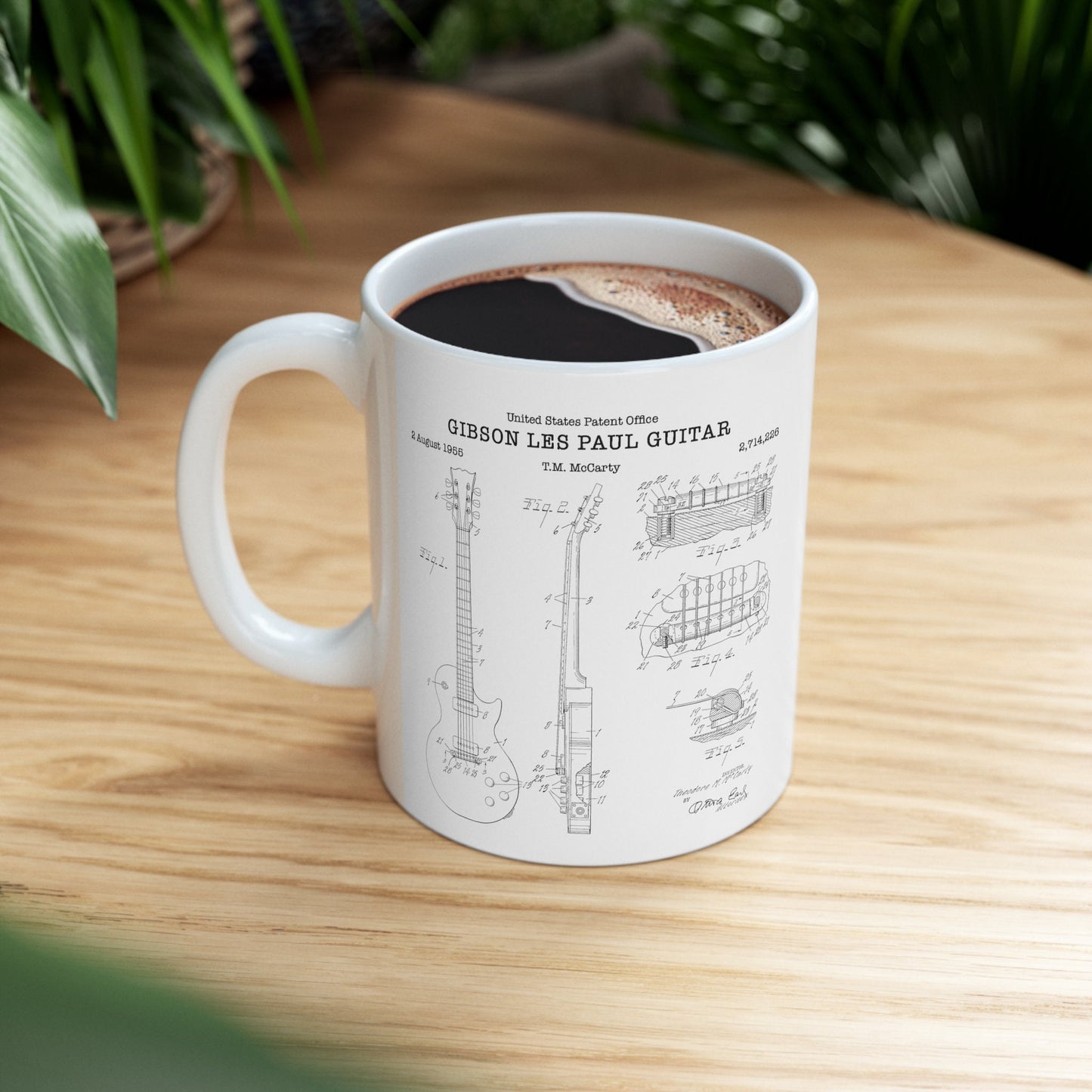 a coffee cup with a drawing of a guitar on it