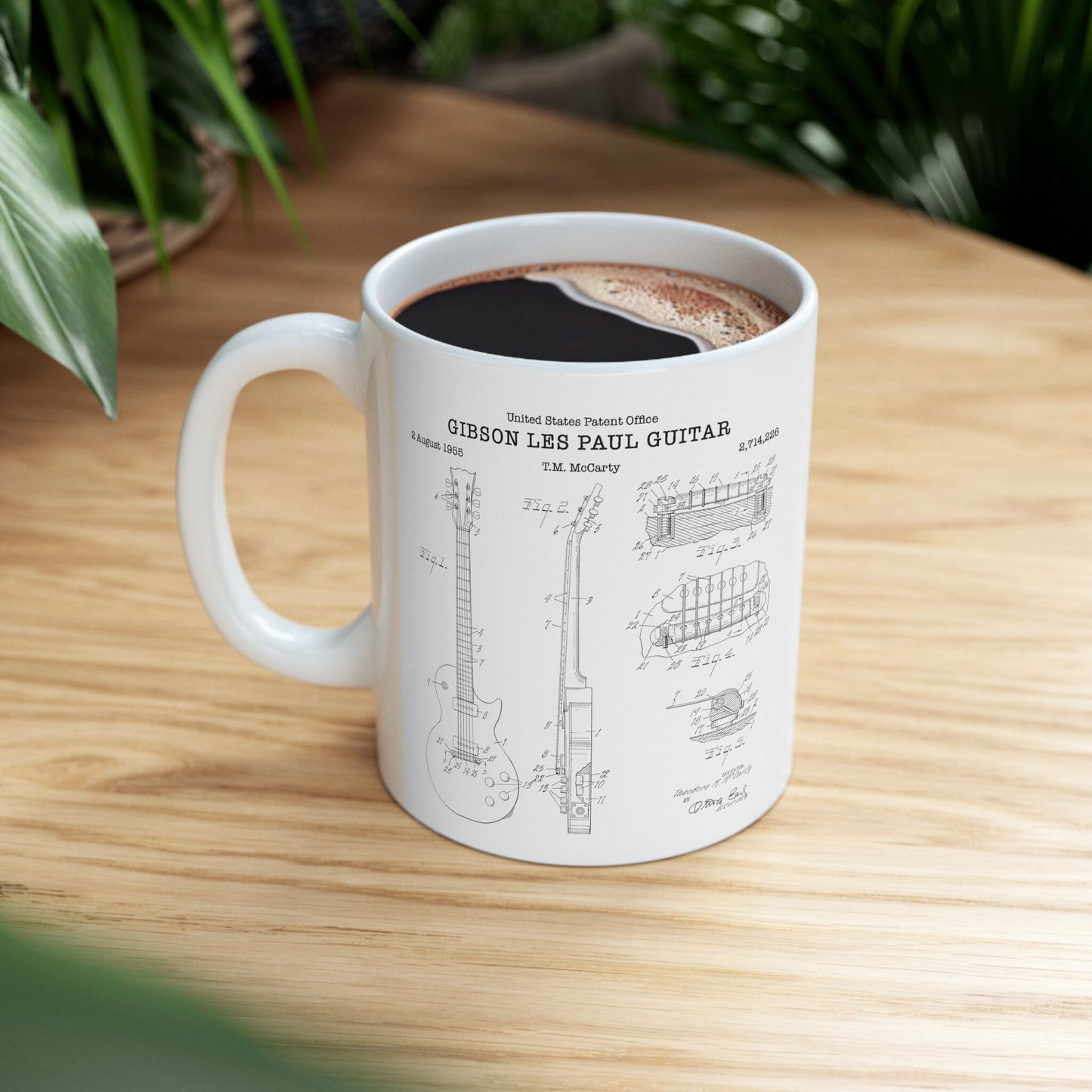 a coffee cup with a drawing of a guitar on it