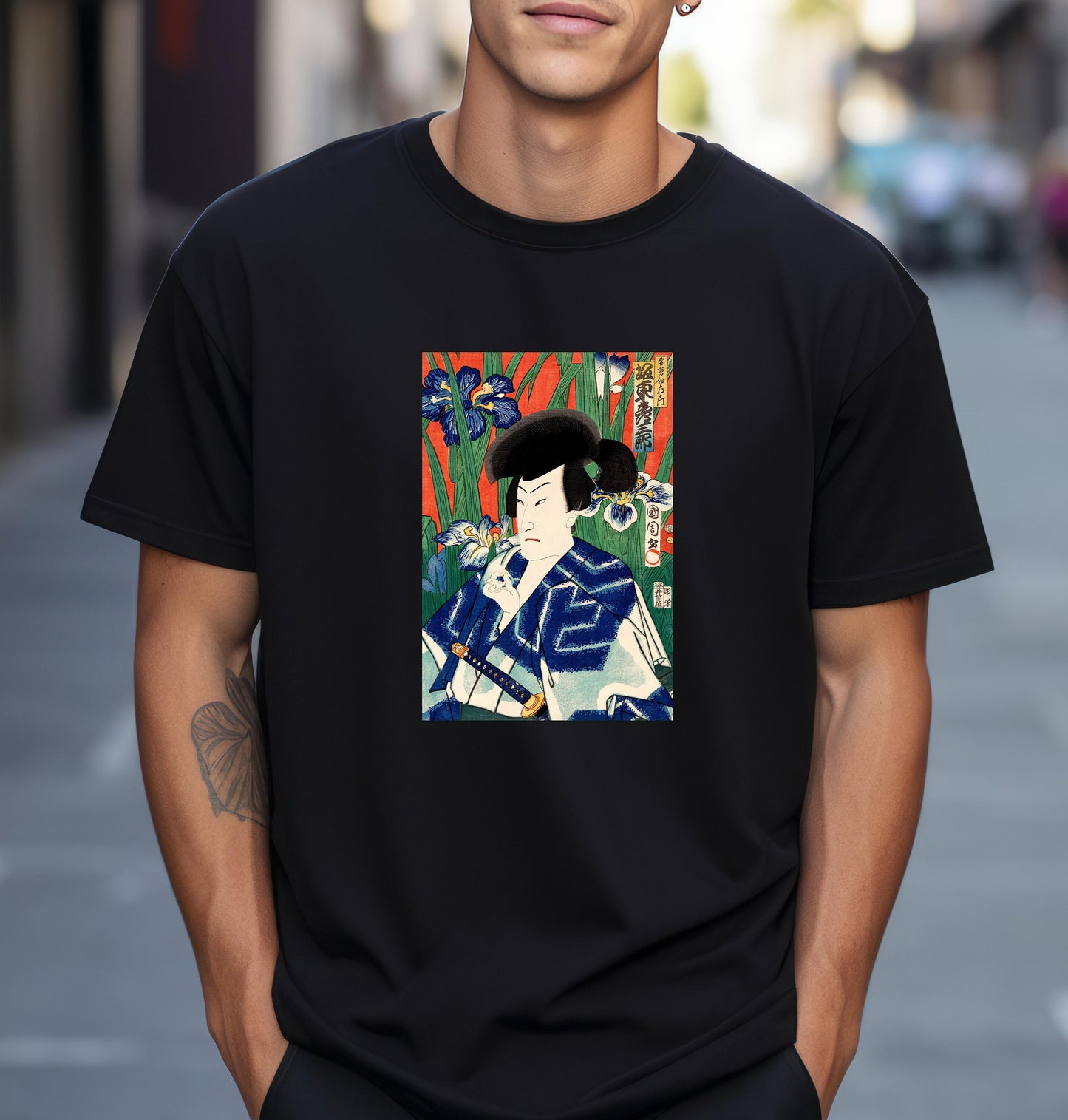 a man wearing a black t - shirt with a picture of a woman on it