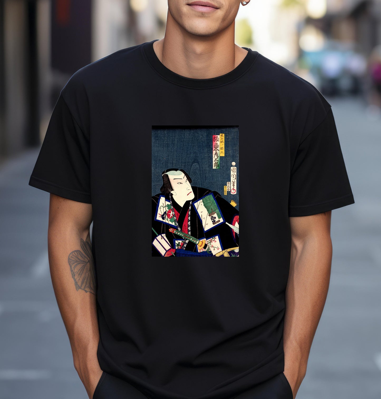 a man wearing a black t - shirt with a picture of a man holding a