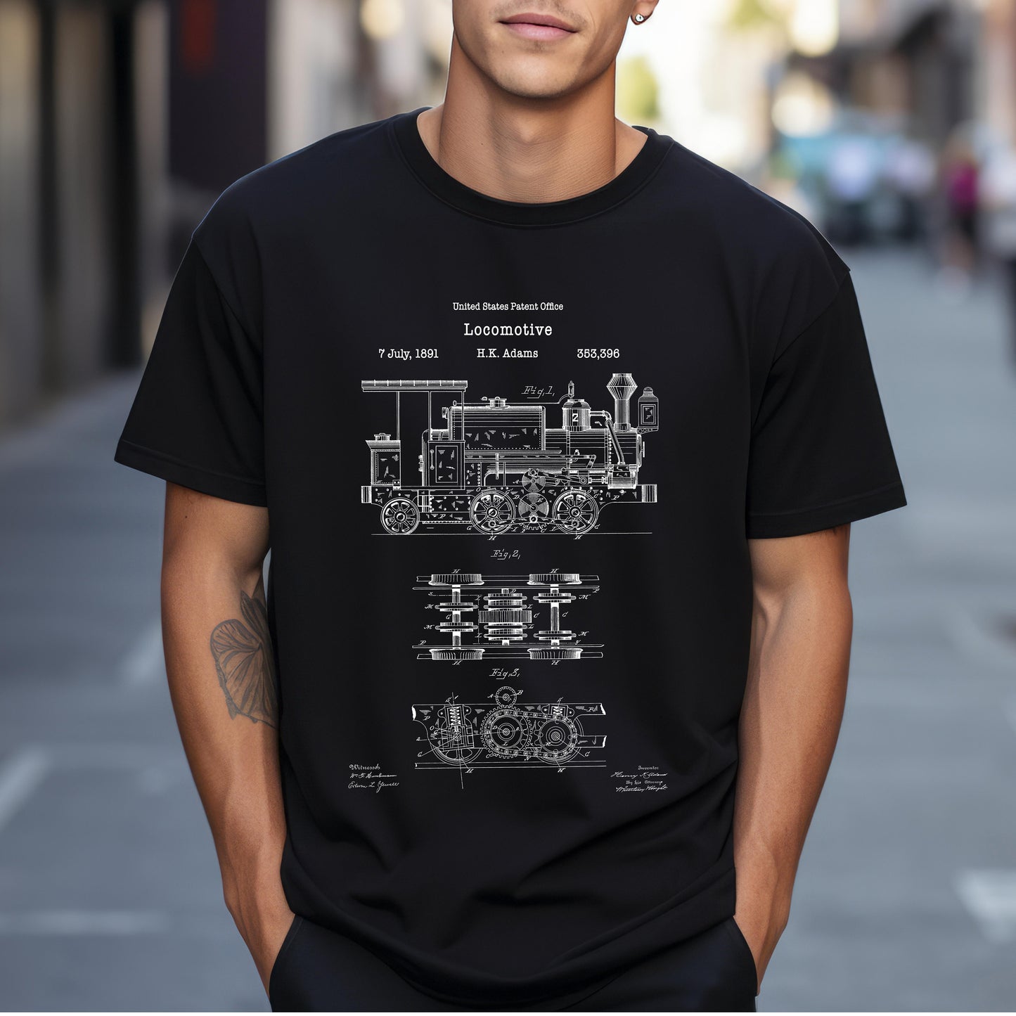 a man wearing a black t - shirt with a blueprint of a train