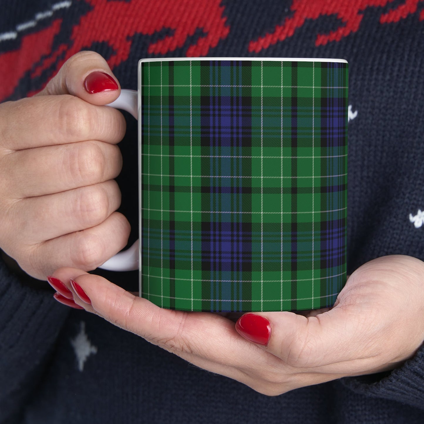 a woman holding a plaid mug in her hands