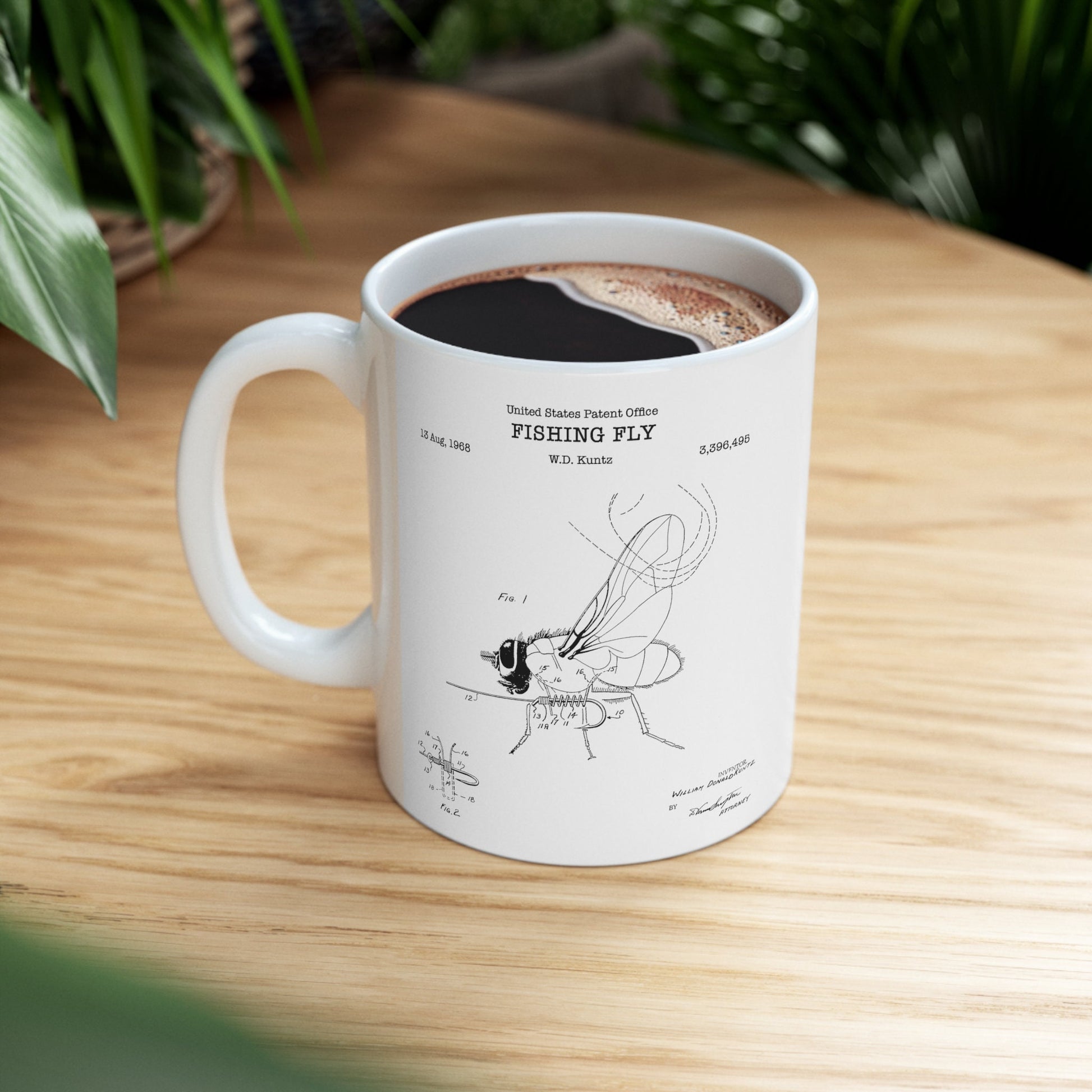 a white coffee mug with a drawing of a fly on it