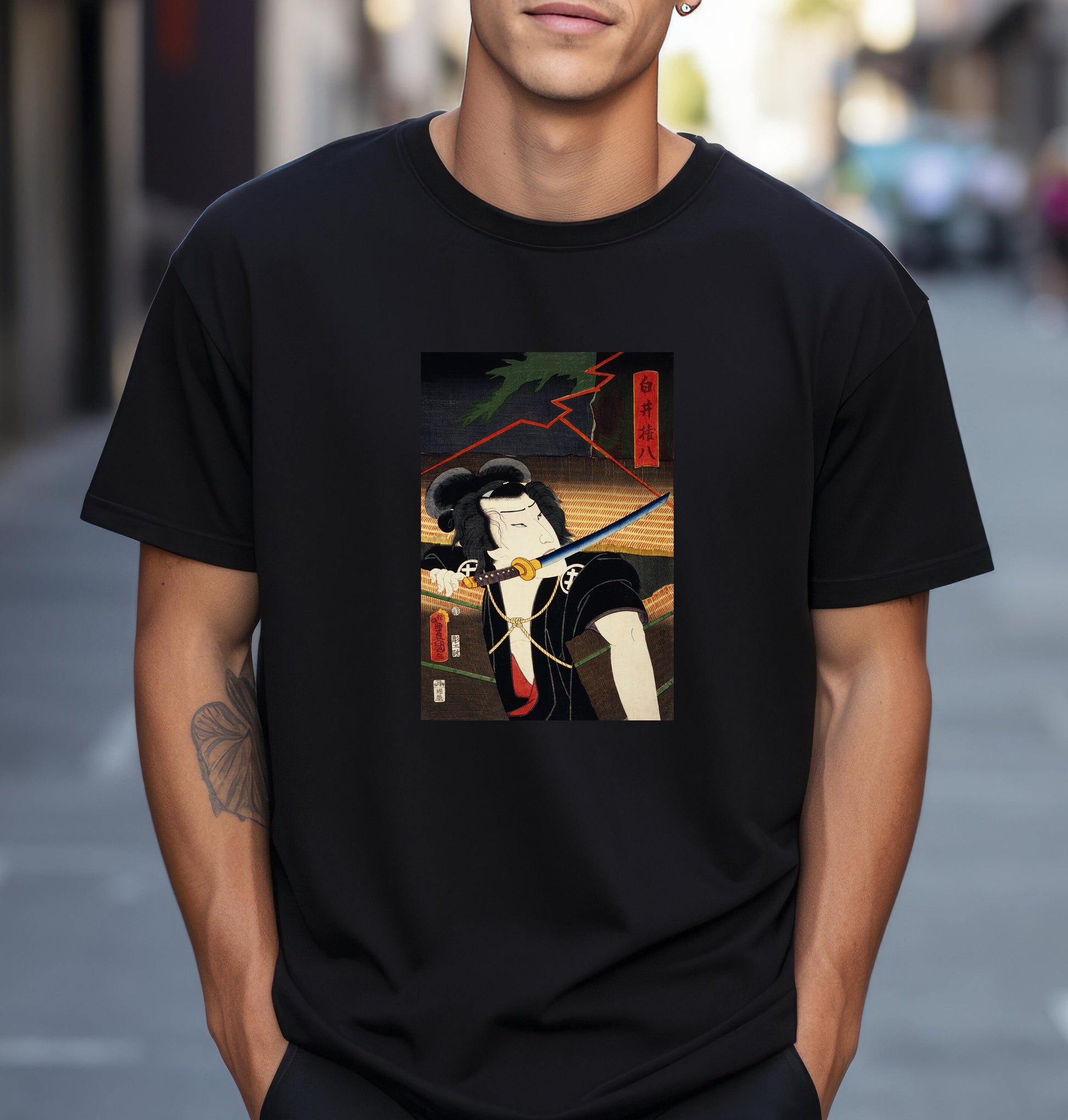 a man wearing a black t - shirt with a picture of a woman holding a