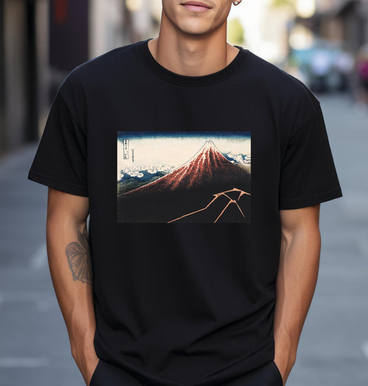 a man wearing a black t - shirt with a picture of a mountain on it