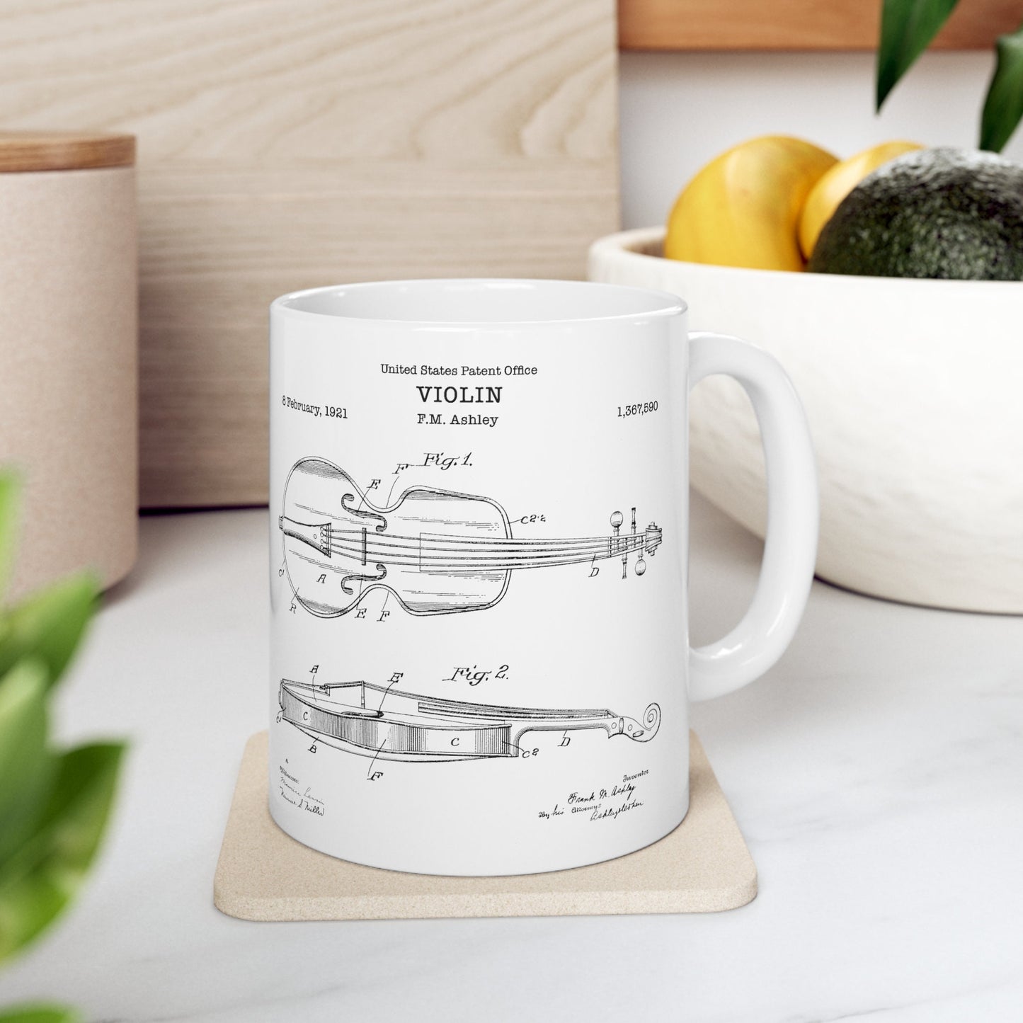 a coffee mug with a violin design on it