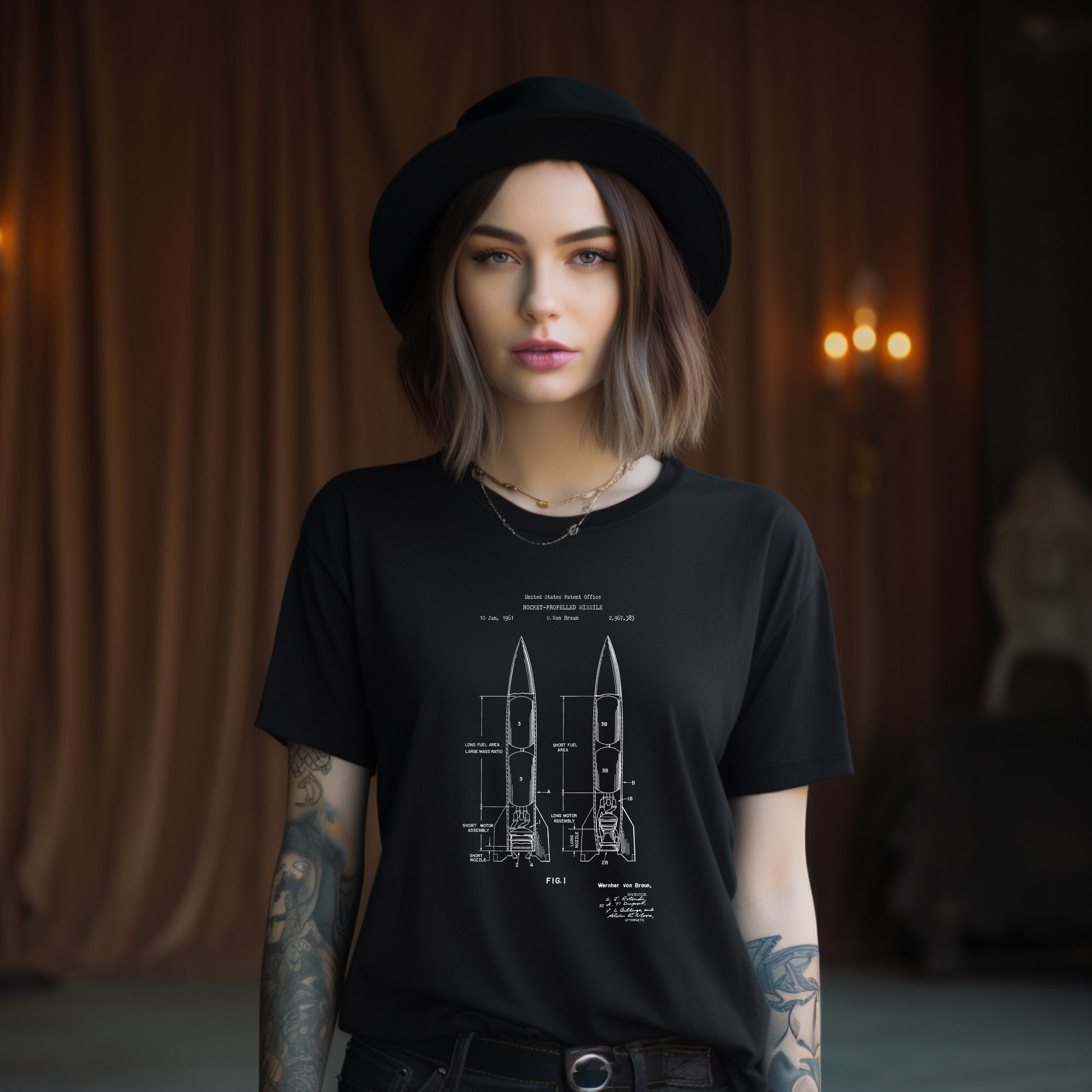 a woman wearing a black shirt with a drawing of a rocket on it