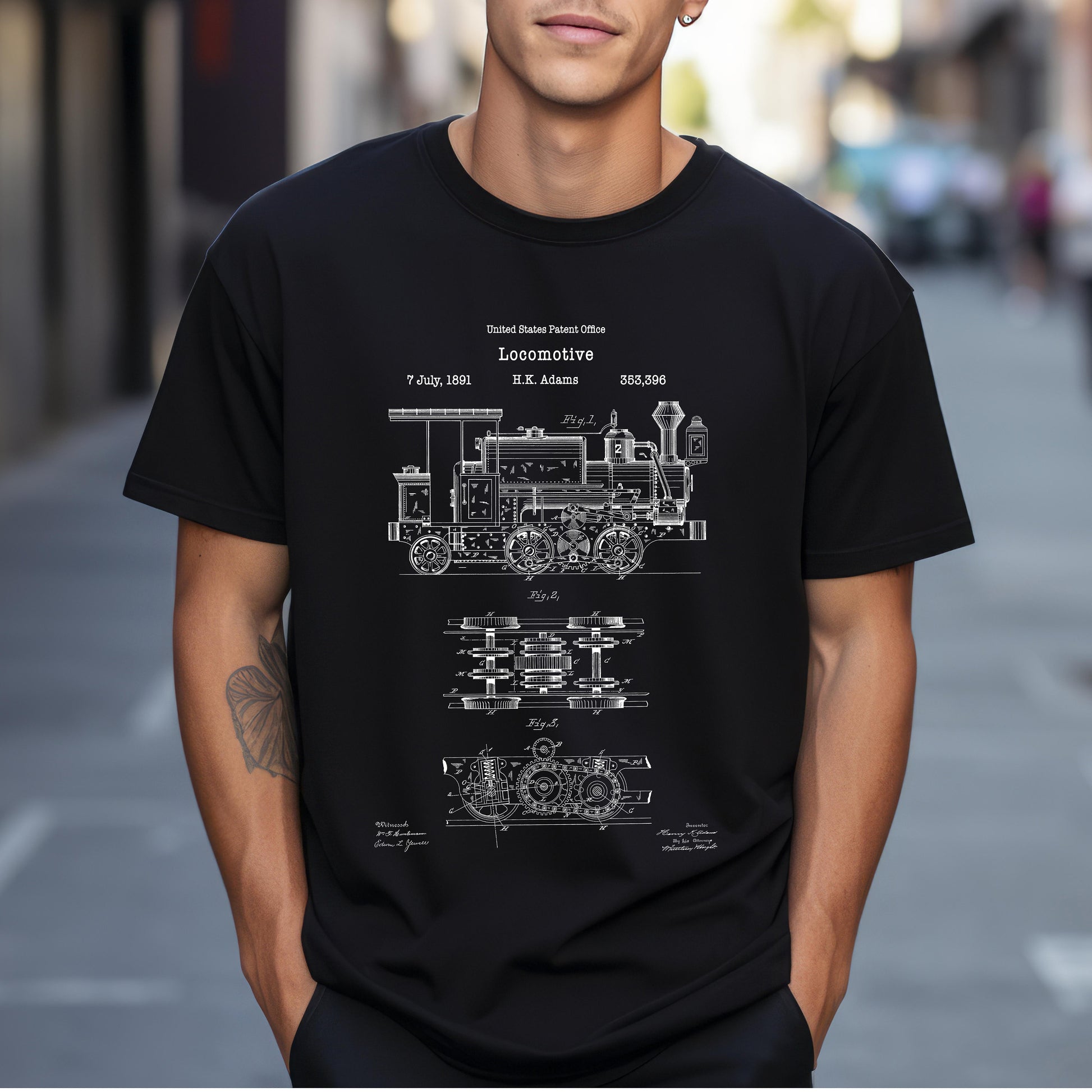 a man wearing a black t - shirt with a blueprint of a train