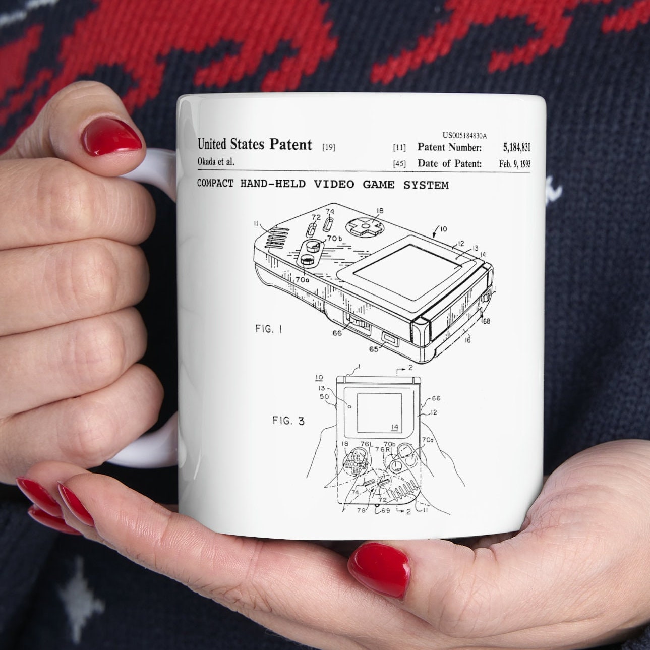 a woman holding a coffee mug with a drawing of a laptop