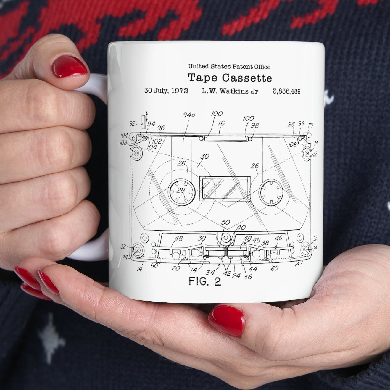 a woman holding a coffee mug with a drawing on it